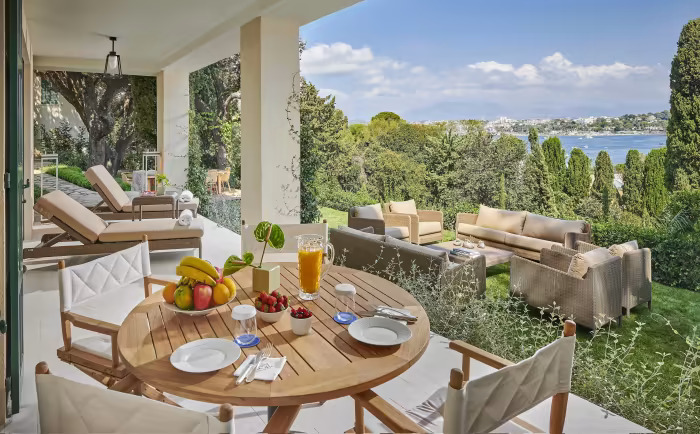 luxury holiday park in the Netherlands with lakeside villa terrace and outdoor breakfast setting