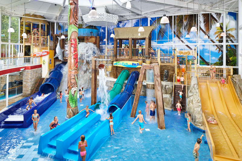 kids enjoying indoor water park with slides at a family holiday park in the Netherlands